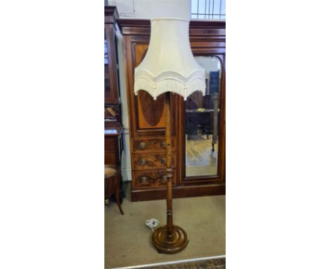 Turned polished beechwood standard lamp and shade.
