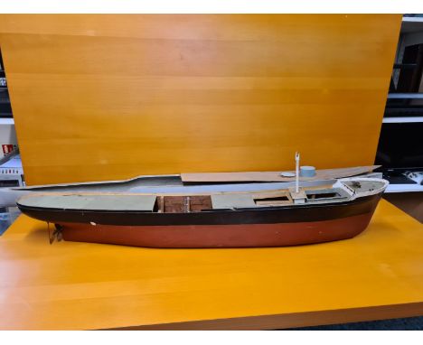 Large wooden model boat hull 127cm long and a fibreglass battleship model boat hull 165cm long together with associated piece