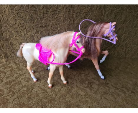 Barbie Mattel 2 horses with saddles, reins and halters.