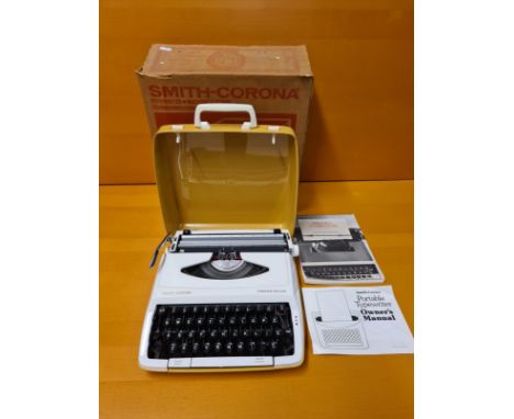 Smith Corona Corsair Duluxe portable typewriter complete with original packaging box, handbook and personal typewriting manua