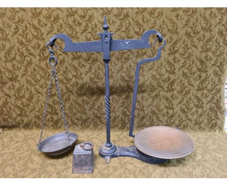 Set of wrought iron balance scales with copper and brass pans together with 7lb ring weight.