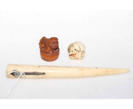 Signed ivory netsuke of a monkey, wood lion netsuke and cigar cutter (3).