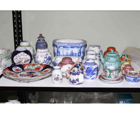 Shelf of Oriental ceramics including ginger jars, Imari plate, teapot.