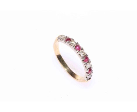 Ruby and diamond nine stone band ring.