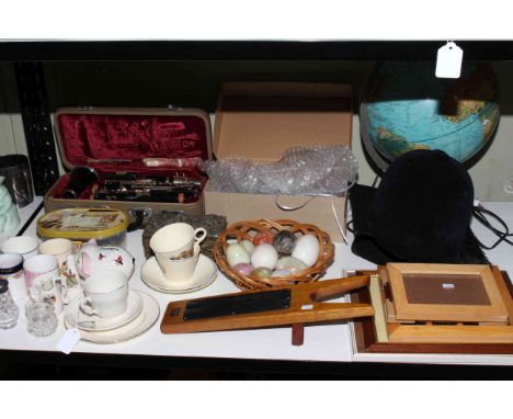 Shelf of ceramics, globe, boxed clarinet, stone eggs, horse riding hat, academic cap, boot jack, baubles, commemorative china