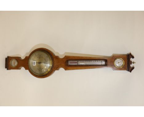 AN EDWARDIAN CROSSBANDED MAHOGANY ANEROID WHEEL BAROMETER, the six inch silvered dial with long thermometer and hygrometer ab