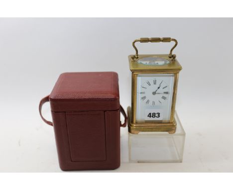 A LATE 19TH CENTURY BRASS 8 DAY STRIKING CARRIAGE CLOCK with twin train movement, white enamel dial, 4 3/4 ins high excluding