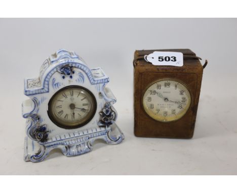 AN EARLY 20TH CENTURY "SOLUS" ELECTRIC TRAVELLING CLOCK in a leather case, 4 ins high and an Edwardian porcelain cased MANTLE