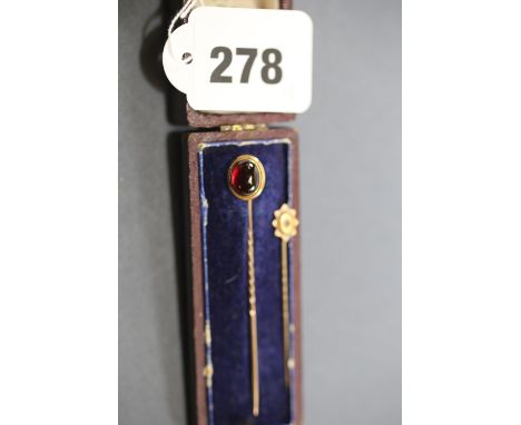 A VICTORIAN CABOCHON GARNET STICK PEN and a 15ct gold sapphire set DITTO.  (2)   