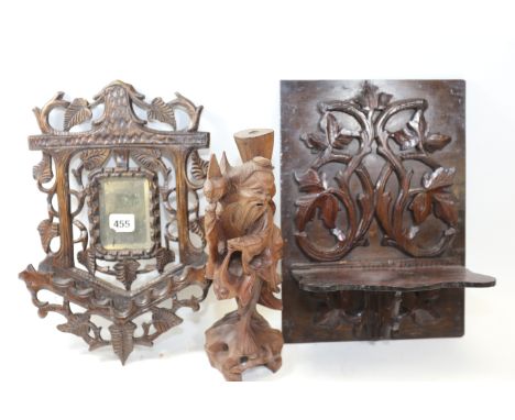 A BLACK FOREST FOLIATE CARVED WOODEN WALL MIRROR, 13 1/2 ins high a carved foliate folding WALL SHELF, a mahogany shield-back