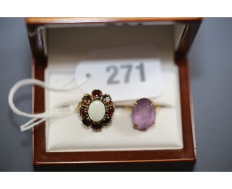 A 9CT YELLOW GOLD OPAL AND GARNET DRESS RING and a 9ct yellow gold amethyst DRESS RING.  (2)   