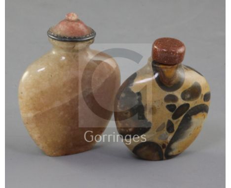 A Chinese pudding stone snuff bottle and a Chinese crystal snuff bottle, 19th century, each of flattened flask form, 6.4cm an