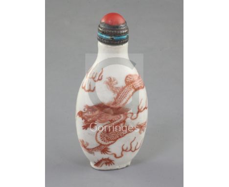 A Chinese iron red enamelled 'dragon' snuff bottle, 19th century, of flattened ovoid form, the finely painted five claw drago