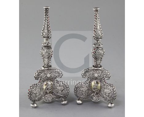 A pair of antique continental silver filigree and gem set bases, (ex-candlesticks?), with monograms on tripod bases, on bun f