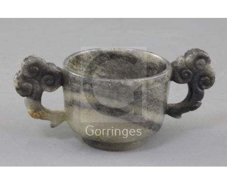 A Chinese grey and black speckled jade two handled cup, 17th/18th century, with a diaper and line border to the exterior and 