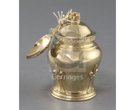 A 1930's silver gilt tea caddy and cover, with matching caddy spoon, by Goldsmiths & Silversmiths Co Ltd, of baluster form, w