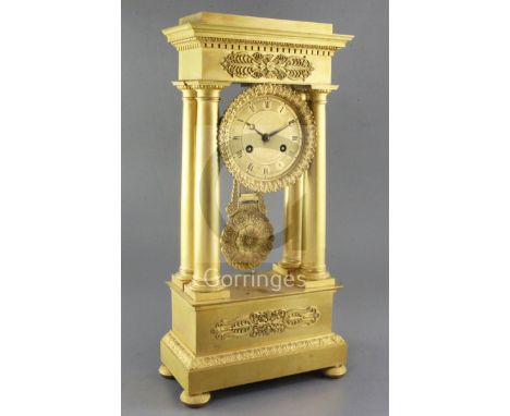 A second quarter of the 19th century French ormolu portico clock, of characteristic form, with 4 inch engine turned Roman dia