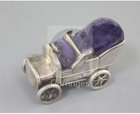 A rare Edwardian novelty silver pin cushion modelled as a vintage car, with rotating wheels, by Levi and Salaman, Birmingham 