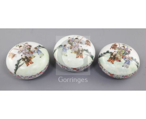 A set of three Chinese famille rose boxes, liners and covers, 19th century, each finely painted with boys in a garden holding