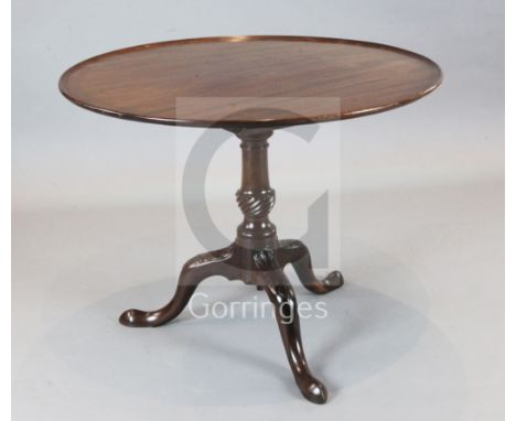 A George III mahogany tea table, with circular top, on canon barrel stem and tripod with concealed castors, W.3ft 1.5in. H.2f