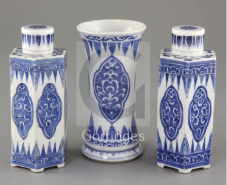 A pair of Chinese blue and white hexagonal jars and covers and a similar beaker vase, Kangxi period, each painted with foliat