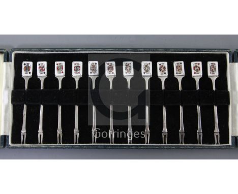 A cased set of twelve Garrard & Co Ltd silver and enamel cocktail forks with playing card terminals depicting Kings, Queens a