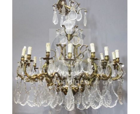 A gilt metal and cut glass fifteen light chandelier, each foliate arm supporting shaped cut glass drops, width 36in.