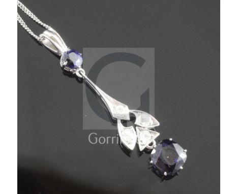 A platinum? sapphire and diamond drop pendant, set with cushion and round cut sapphires and four round cut diamonds, on a lat