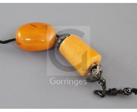A Chinese silver filigree and amber pendant, late 19th century, possibly formerly part of a court necklace, the bead 3.6cm an