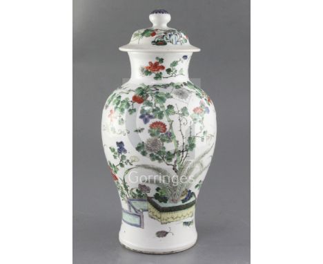 A Chinese famille verte vase and cover, late 19th century, finely painted with a rockwork garden containing insects, a spider