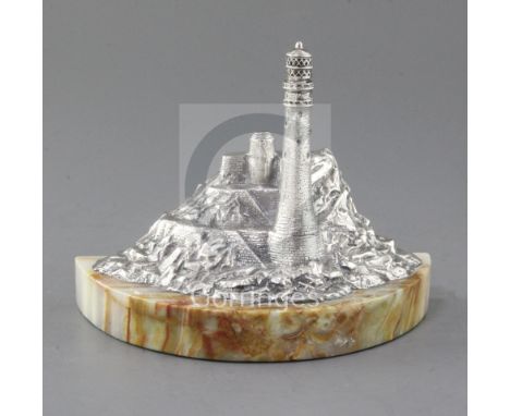 A modern silver miniature model of a lighthouse in a rocky coastline by J.A. Campbell, on a demi-lune onyx base, London, 1993