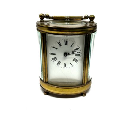 Vintage oval brass case carriage clock 