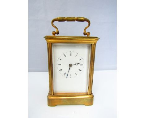 A brass carriage clock, with enamel dial and 8 day time piece