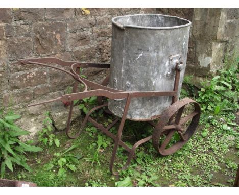A vintage garden water barrow, the ironwork frame with spoke wheels supporting a removable galvanised bucket/container