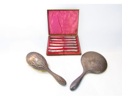 A cased set of six silver-handled butter knives, William Devenport, Sheffield, 1914; a silver hand mirror, Chester, 1921, wit