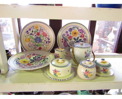 A collection of Poole Pottery wares comprising: three circular dishes with floral decorations and various printed and painted