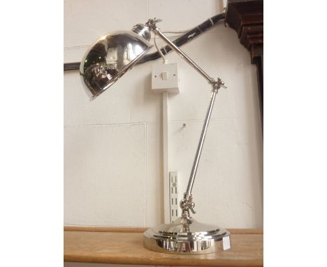 A contemporary three jointed anglepoise type tall desk lamp with butterfly hinges, raised on a stepped circular base with a s