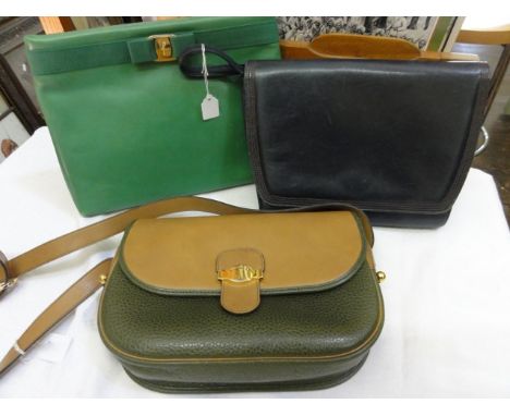 A Christian Dior shoulder bag in green and buff coloured leather with a gilt clasp, an emerald green clutch bag and a navy sh