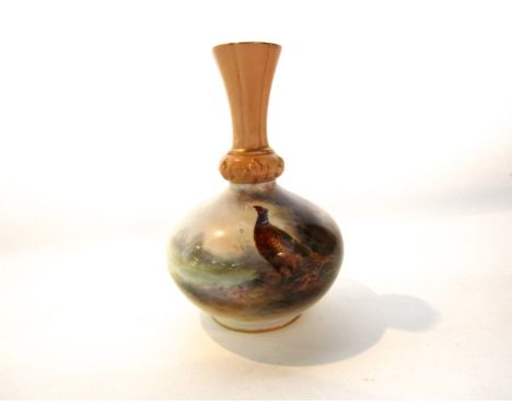 A Royal Worcester ivory ground vase with painted decoration of a pheasant in a landscape signed J.A.S Stinton and with green 