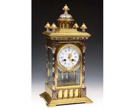 A good quality 19th century brass and enamelled four pane mantel clock, the case work with turned and decorated columns, scro