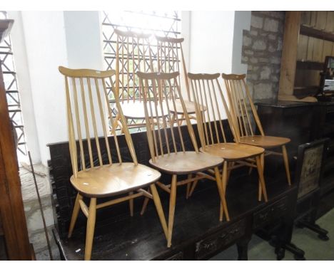 A set of six light Ercol elm and beechwood high stick back dining chairs with cow horn rails and splayed, turned and tapered 