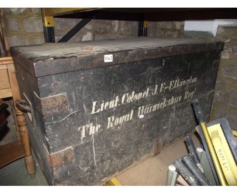 A vintage stained pine and steel reinforced travelling trunk/chest with hinged lid and iron work side carrying handles, the f
