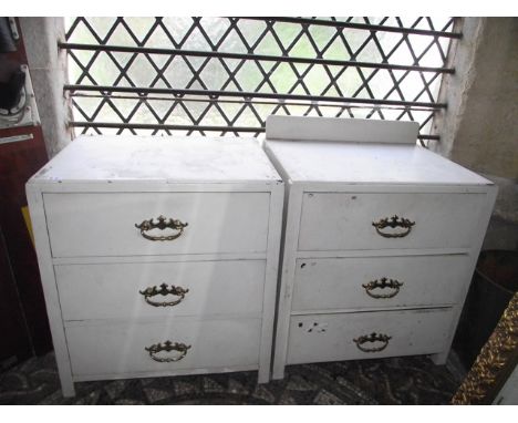 A pair of painted oak three drawer bedroom chests containing a quantity of miscellaneous hand tools and accessories 