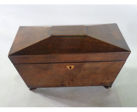A 19th century sarcophagus shaped tea caddy, veneered principally in mahogany with a satinwood shield shaped lock escutcheon,