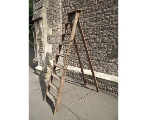 A vintage eight rung A framed folding wooden step ladder (to be sold for decoration purposes only)