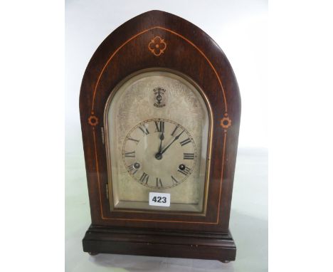 An Edwardian lancet shaped mantel clock with boxwood string inlay, the arched silvered dial with chased detail and silent/chi