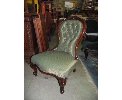 A Victorian spoonback drawing room chair with serpentine upholstered seat and button back within a shaped, carved and moulded