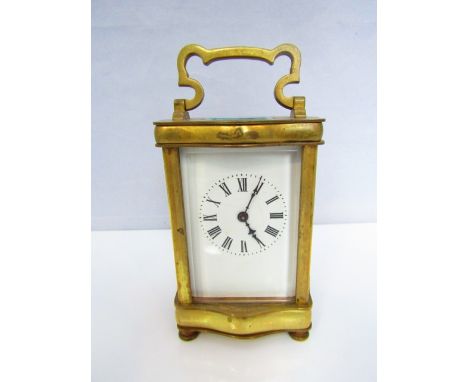 A brass carriage clock with enamel dial and 8 day time piece
