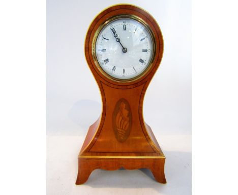 An Edwardian satinwood mantel clock with balloon shaped case, with ebony string inlay and conch shell detail, with enamelled 