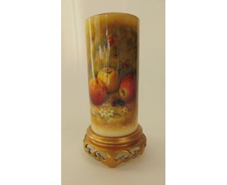 A Royal Worcester ivory ground vase of cylindrical form raised on a circular pierced gilded base with painted panel of fruit 